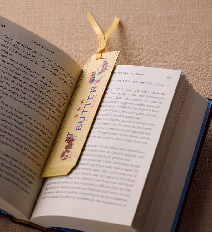 RIFLE PAPER CO. Butter Stick with It Bookmark, 1.75" W x 6" L, Playful Butter Stick with It Text, Wipe-Clean Saffiano Polyurethane, Grosgrain Ribbon, Gold Foil Logo